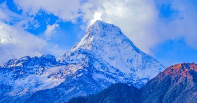 snow covered mountain under cloudy sky during daytime