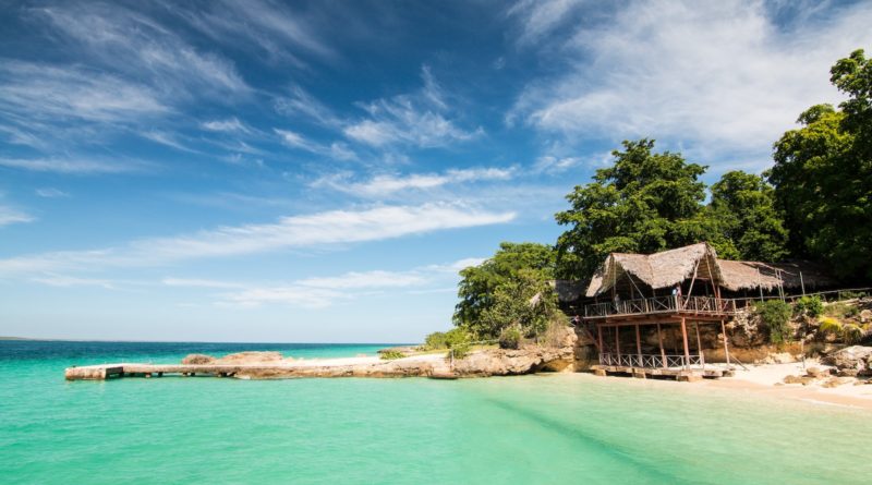 brown wooden house near beach