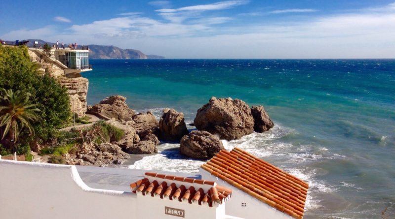 white and brown concrete building near sea during daytime
