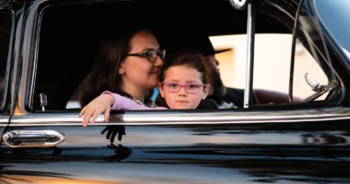 girl and woman inside black car