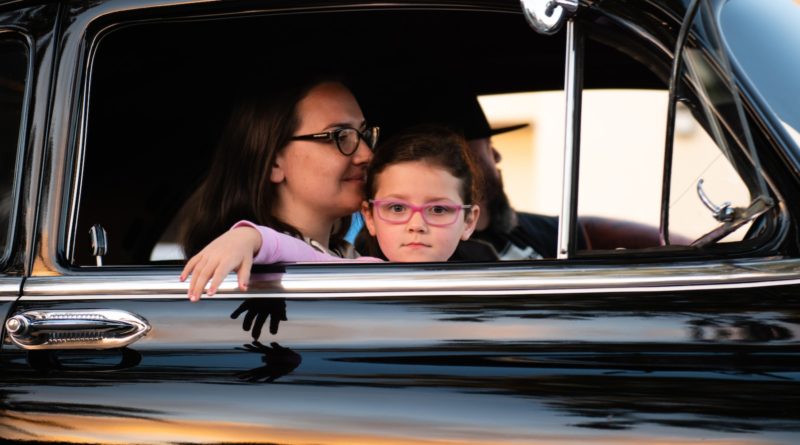 girl and woman inside black car