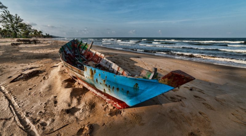 blue boat on seashore