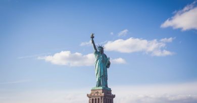 Statue of Liberty, New York under white and blue cloudy skies