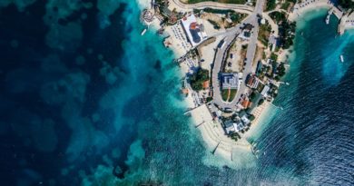 aerial photography of house beside body of water