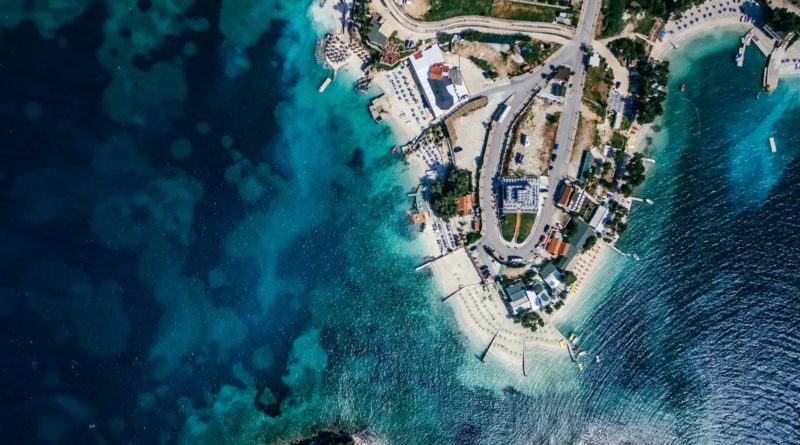 aerial photography of house beside body of water