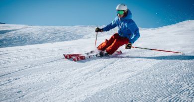 man ice skiing on hill