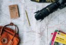 flat lay photography of camera, book, and bag