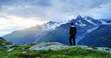 person standing in front of mountain landscape photography