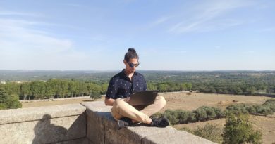 woman in black shirt sitting on gray concrete bench during daytime