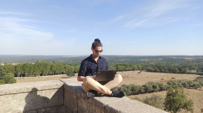 woman in black shirt sitting on gray concrete bench during daytime