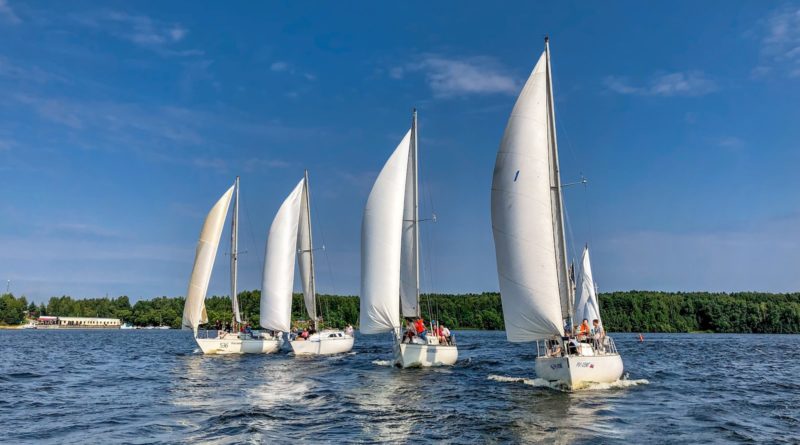 white sail boat on sea under blue sky during daytime