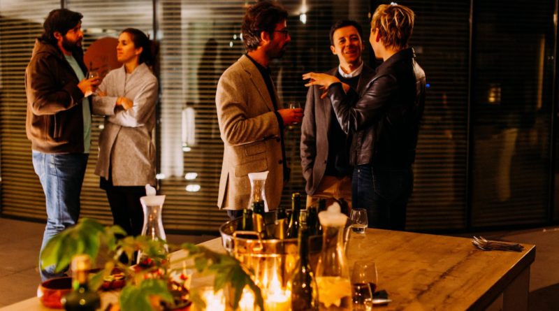 five person standing while talking each other