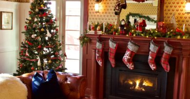 green christmas tree with baubles near fireplace