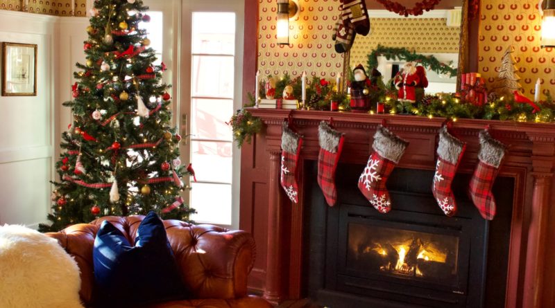 green christmas tree with baubles near fireplace